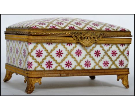 A stunning 19th century ceramic and ormolu jewellery casket, fitted with a hinged lid and raised on four feet, marked Limoges