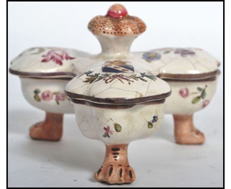 A 19th century Continental Majolica table cruet / salts, raised on tripod pad paw feet with lidded top removing to reveal a s