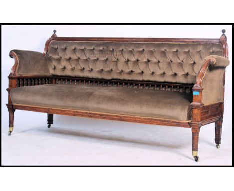 A good Victorian oak gallery back salon sofa settee being raised on turned legs with brown velour upholstered overstuffed sea