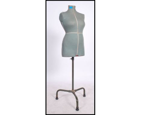 A vintage 20th century Singer dress makers female mannequin bust raised on an ebonised adjustable tubular tripod base.