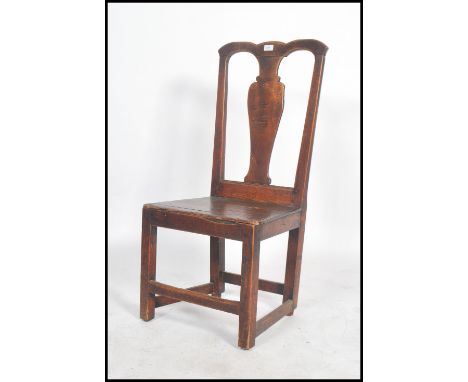 An 18th century north country oak dining chair having a panel seat with square legs united by peripheral stretcher with shape