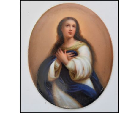 A 19th century Ecclesiastical hand painted ceramic tondo portrait miniature plaque of oval form depicting The Virgin Mary hol