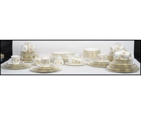 An extensive Royal Doulton twelve person setting dinner service in the ' Yorkshire Rose ' pattern consisting of main plates, 