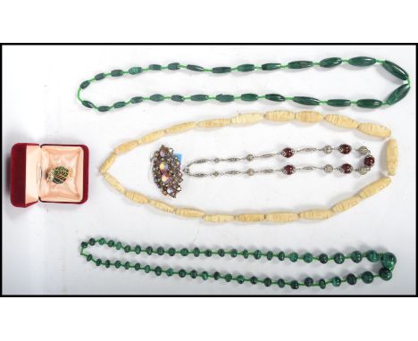 A group of vintage costume jewellery to include a gold plated and enamel owl, moss agate bead necklace, white metal filigree 