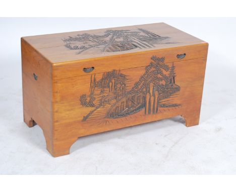 A mid century camphor wood Chinese trunk / blanket box having panel sides with hinged top, all over carved details 56x101x50c