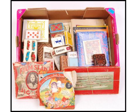 A collection of vintage 20th century board games, playing cards and puzzles. To include Snow White and the Seven Dwarfs, Cuna