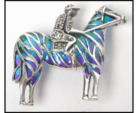 A ladies silver and plique a jour adorned brooch / pendant in the form of a jockey and rider - horse racing - hunting interes
