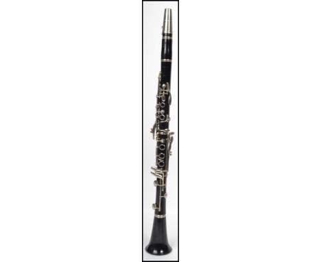 A vintage Boosey and Hawkes of London Regent clarinet having an ebonised body with chrome metal detailing. Measurements: 68 c