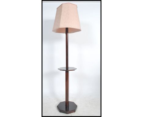 A 1930's Art Deco standard lamp having tier centre and terraced base being complete with the shade. Recently lacquered. Measu
