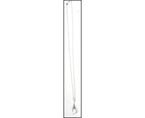 A 20th century Art Deo style silver and opal pendant necklace being set to a chain. Complete in the presentation box
