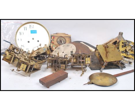 A good group of vintage 20th century and other clock spares and repairs to include enamel faces, movements, hands, keys etc. 