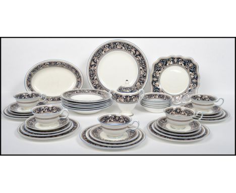 A 20th century Wedgwood Florentine part tea and dinner service service decorated in a cobalt ground with neo classical scenes