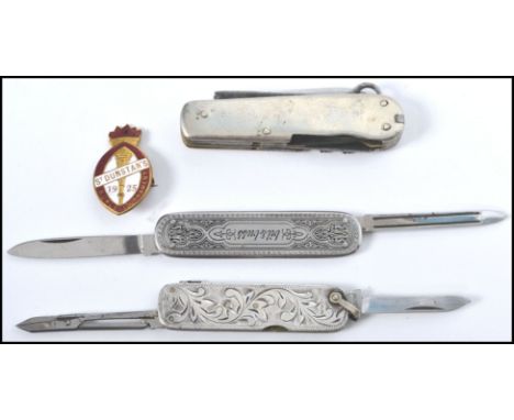 A group of vintage pen knives to include a rococo influence sterling silver example, a believed Victorian example and a machi