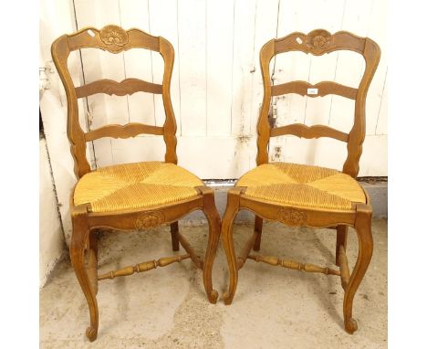 A pair of French oak ladder-back dining chairs 
