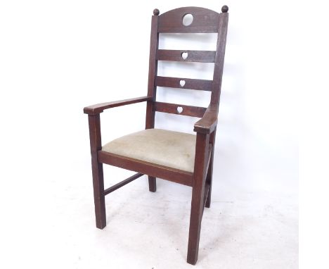 An Arts and Crafts oak ladder-back armchair, with heart and circle cut-outs 