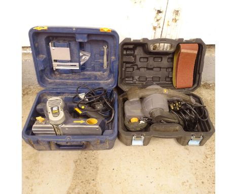 A Pro 3-blade planer, in case, and a Titan belt sander, in case 
