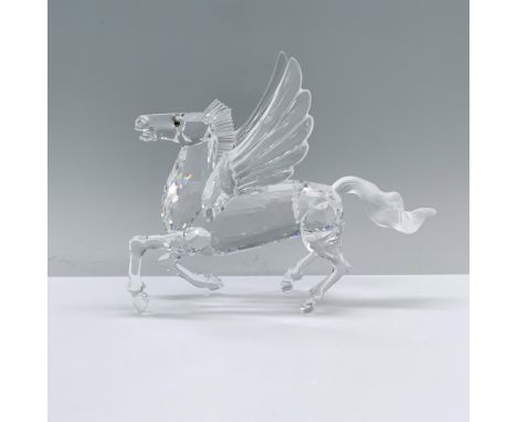 A clear crystal Pegasus designed to stand on hind legs and tail with wings spread wide featuring amber-colored eyes. Swarovsk