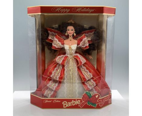 Dressed in a red ribbon and delicate white lace dress with gilt accents, wearing a tiara and jewelry with red crystals. Fifth