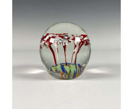 Clear globe has delicate red and white flowers growing out of a blue, green, and orange base. A single bubble rises in the mi
