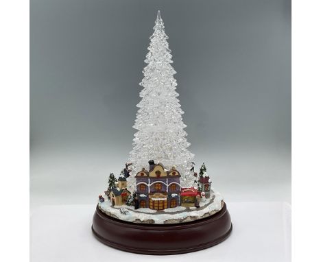 Beautiful Christmas centerpiece of a crystal tree surrounded by a winter small town scene. The tree changes color as a train 