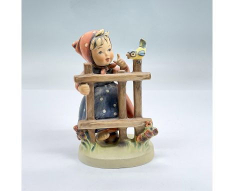Hand painted figure of a girl in a red dress, polka dot apron, polka dot red head scarf, holding on to a fence looking at a l