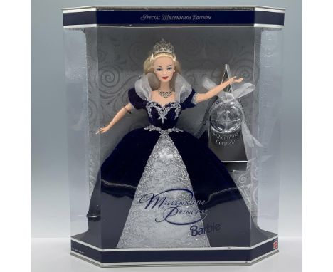 Dressed in a blue velvet and glittery lace gown and wearing a silver-colored tiara. Includes a Happy New Year Millennium keep