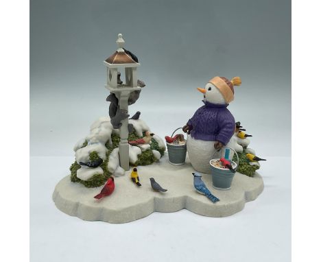 Hand painted winter scene depicting a snowman looking surprised as he comes upon squirrels eating the food he has put out for