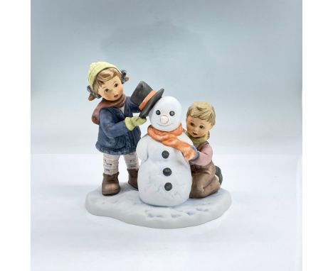 Hand painted figure of two boys putting the finishing touches of a hat and scarf on a snowman. Berta Hummel and Goebel backst