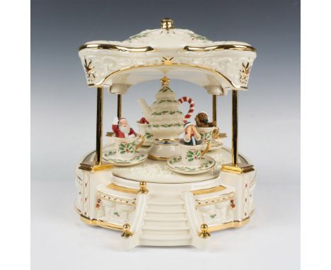 Spectacular musical amusement park ride plays We Wish You a Merry Christmas. Ornate canopy shelters hand-painted figures of S