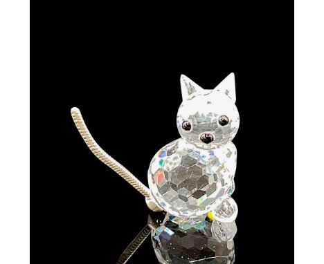 Clear, faceted body and face with black button eyes and nose. Silver coiled tail. Swarovski backstamp. 7659 031 000. This ite