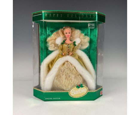 New in box Barbie doll in her stunning gold holiday dress. Model #12155. This item has its original box. SKU: 074299121555. I