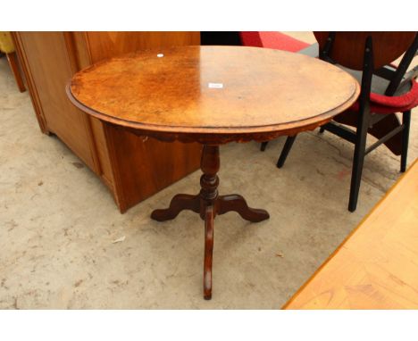 AN OVAL VICTORIAN WALNUT TABLE ON A LATER TRIPOD BASE 33" X 19" 