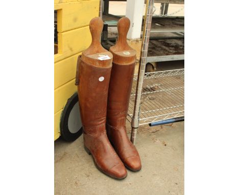 A PAIR OF VINTAGE LEATHER RIDING BOOTS AND WOODEN ALKIT SERVICE AND SPORTING OUTFITTERS BOOT STRETCHERS 