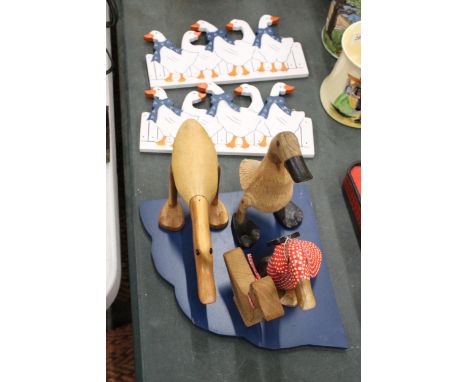 FOUR HAND CARVED WOODEN DUCKS, A SHELF AND TWO WALL HANGING 