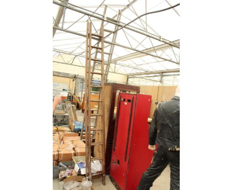 A VINTAGE 22 RUNG WOODEN EXTENDABLE TWO SECTION LADDER 