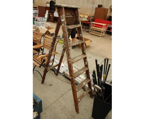 A VINTAGE 6 RUNG WOODEN STEP LADDER BEARING THE NAME GRAVITY-RANDALL 