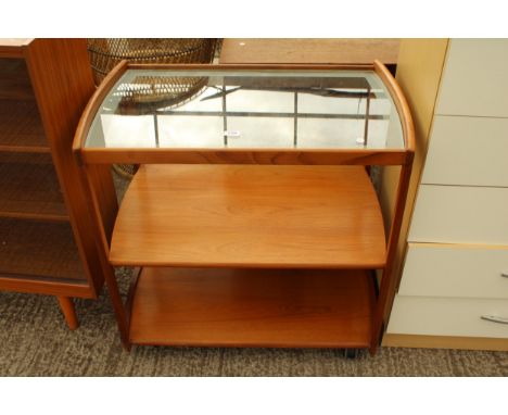 A RETRO TEAK THREE TIER TROLLY THE UPPER SHELF BEING GLASS 