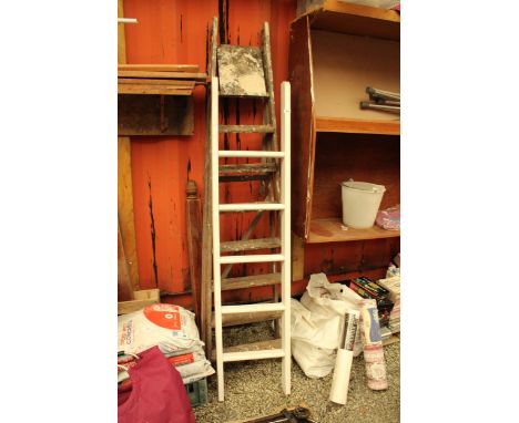 A WOODEN WHITE PAINTED FIVE RUNG LADDER AND A FURTHER VINTAGE WOODEN SEVEN RUNG STEP LADDER 