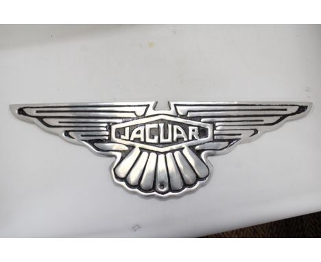 A CHROME JAGUAR SIGN 