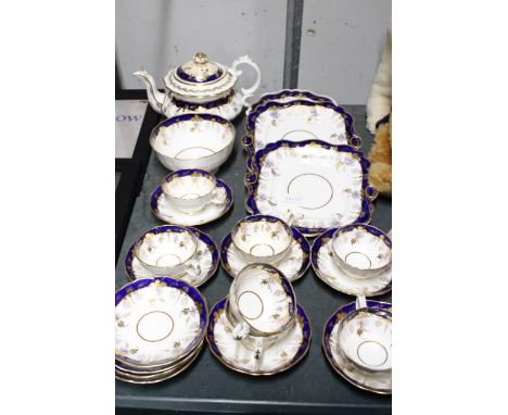 A VICTORIAN TEASET WITH COBALT BLUE AND GOLD GILT FLORAL DECORATION TO INCLUDE A TEAPOT, SUGAR BOW, CAKE PLATES, CUPS AND SAU