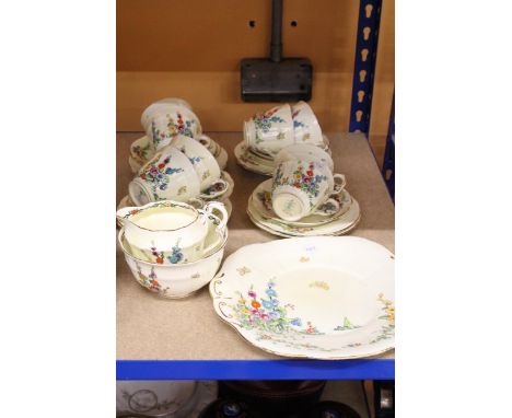 A VINTAGE CROWN STAFFORDSHIRE TEASET IN PALE YELLOW WITH FLORAL DECORATION TO INCLUDE, A CAKE PLATE, CREAM JUG, SUGAR BOWL, C