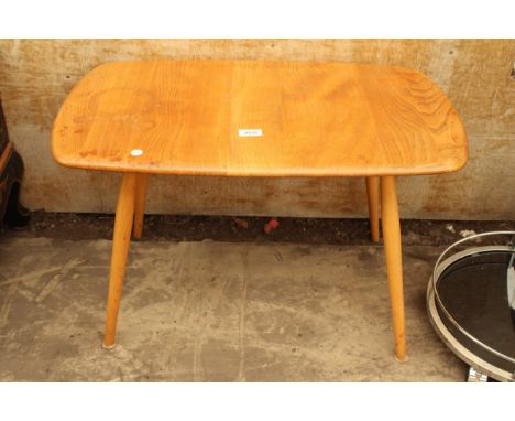 AN ERCOL BLONDE ELM AND BEECH COFFEE TABLE 29" X 17" 