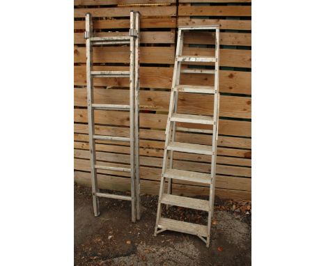 A SEVEN RUNG ALUMINIUM STEP LADDER AND A FURTHER 12 RUNG TWO SECTION EXTENDING LADDER 