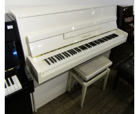 Yamaha (c1993).  A modern style model M110 upright piano in a white case together with a matching stool.