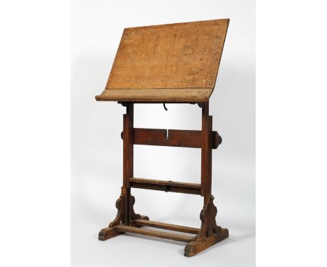 A Victorian oak easel, late 19th century, with adjustable slope and height, on scroll bracket supports a d block legs joined 