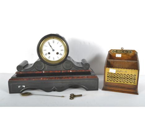 A Victorian black slate and red marble mantel clock and an oak and brass letter box, the clock of reeded drum shape on scroll