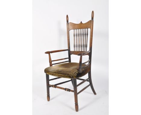 An Arts and Crafts oak chair, in the manner of William Birch, with bobbin turned spindles and upholstered seat, 114cm high