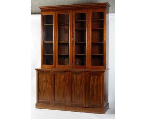 A George III style mahogany bookcase, 19th century, with Greek-key pattern cornice above four glazed doors enclosing adjustab