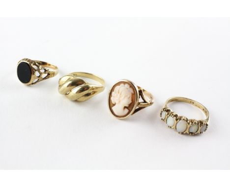 A collection of four rings to include an onyx signet ring, A cameo ring, A half hoop opal ring and a plain dress ring. Each a