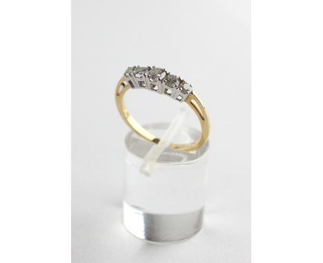 A yellow and white metal half hoop ring. Set with five graduated round brilliant cut diamonds estimated to weigh a total of 0